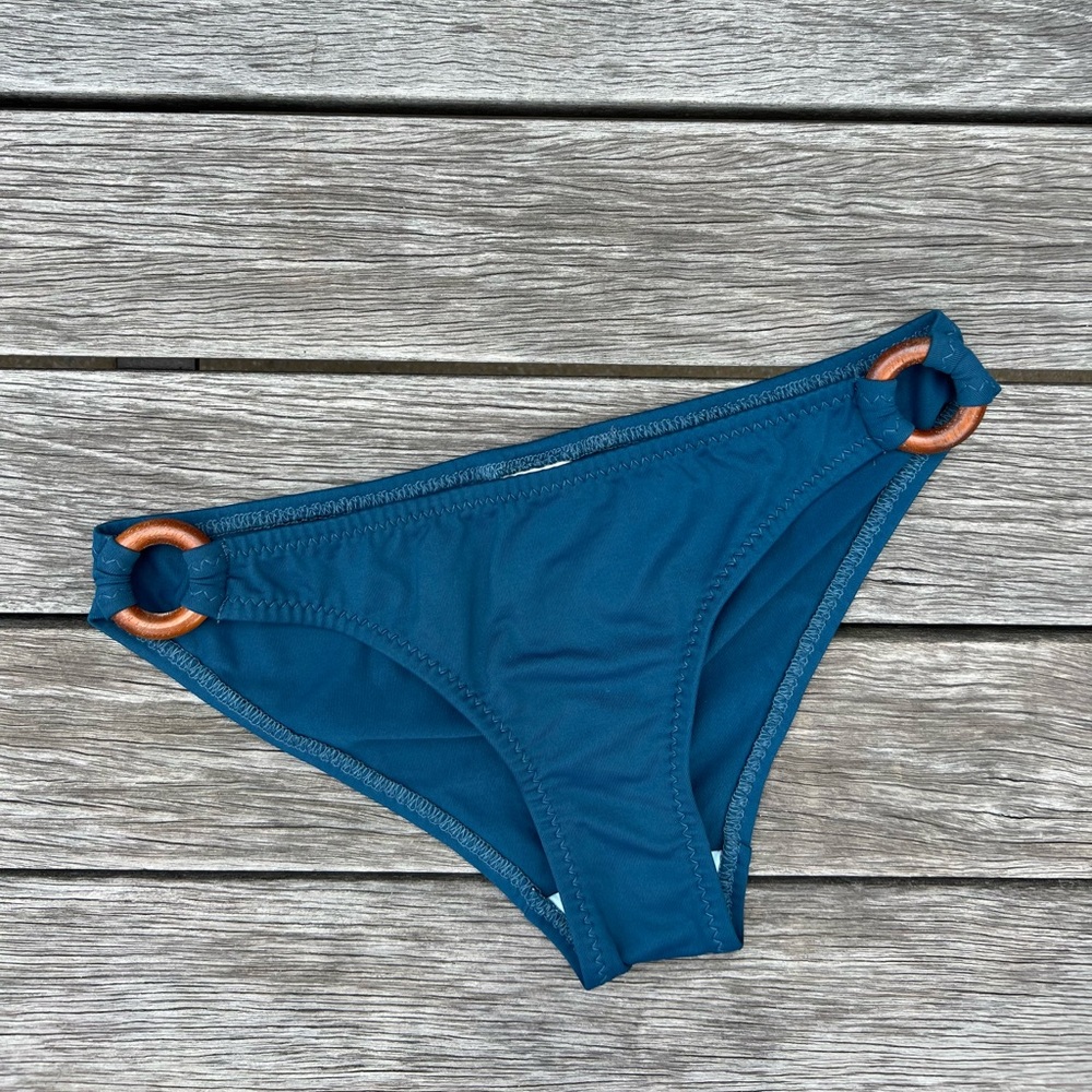 Malia Mills ‘Summer of Love’ blue bikini bottom with wooden O rings at sides.